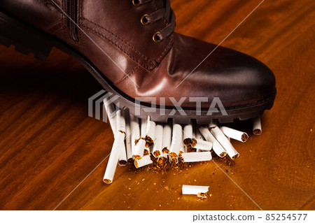 shoes trampling down on cigarettes shoes trampling down on cigarettes 85254577