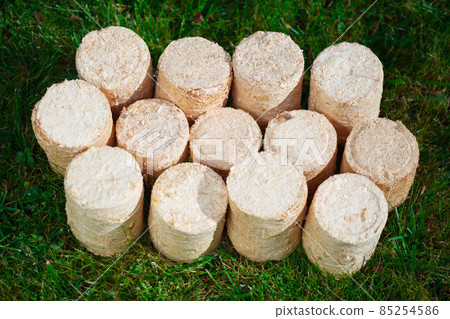 wooden pellets on green grass background wooden pellets on green grass background 85254586