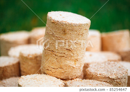 wooden pellets on green grass background wooden pellets on green grass background 85254647