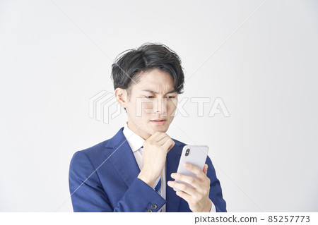 Businessman smartphone thinking white background Businessman smartphone thinking white background 85257773