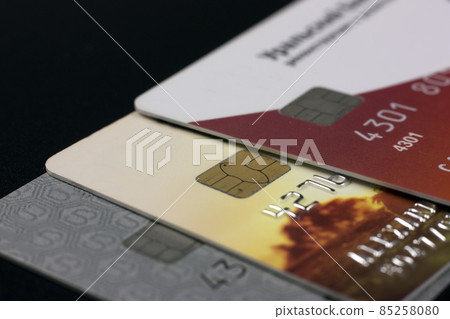 A lot of different bank credit cards with chips on a black background A lot of different bank credit cards with chips on a black background 85258080
