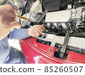 Car mechanic Hands during oil change work 85260507