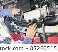 Car maintenance in the bonnet mechanic's hand 85260515