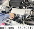 Car maintenance in the bonnet mechanic's hand 85260519
