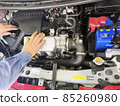 Hands of a mechanic during car maintenance 85260980