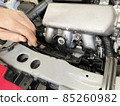 Car maintenance in progress Engine room and mechanic's hands 85260982