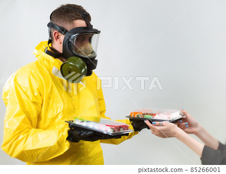 a food deliveryman in a yellow suit and a protective gas mask 85266001