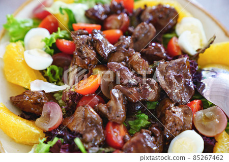 pieces of roasted meat on fresh vegetables with quail eggs. pieces of roasted meat on fresh vegetables with quail eggs. 85267462