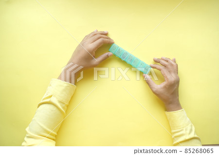 man's hands taking medicine from a pill box on yellow background man's hands taking medicine from a pill box on yellow background 85268065