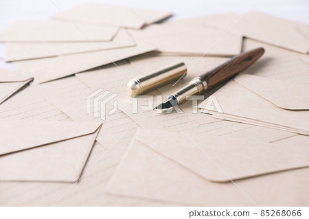 envelope , empty paper and fountain pen on table envelope , empty paper and fountain pen on table 85268066