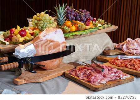 Colored buffet with seasonal fresh fruits and different kind of Ham 85270753