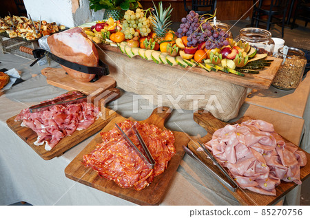 Colored buffet with seasonal fresh fruits and different kind of Ham 85270756