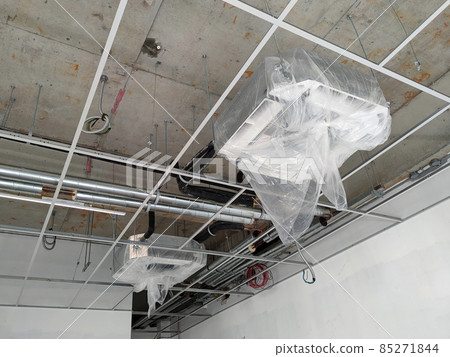 SELANGOR, MALAYSIA -MARCH 5, 2021: Installation of ceiling cassette air-condition units. Mounted on the ceiling, and has the ability to cool the space more efficiently. 85271844
