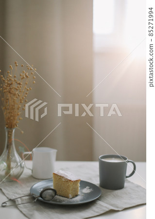 breakfast with a piece of fresh homemade cake, pitcher and cup of coffee on a table breakfast with a piece of fresh homemade cake, pitcher and cup of coffee on a table 85271994