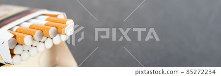 Open pack of cigarettes with several stretched cigarettes close-up 85272234