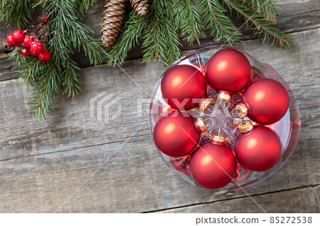 Holiday Xmas concept. Christmas red balls on a rustic wooden background. Top view flat lay. Copy space. 85272538
