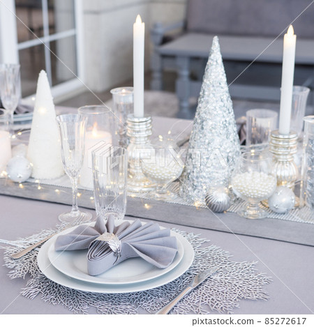 Beautiful table setting with Christmas decorations. Silver colors 85272617