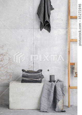 Organic waffle linen towels, bamboo toothbrushes, bathroom zero waste accessories in grey shades in contemporary bathroom interior. Daily body care, spa and wellness zero waste bathroom concept 85272846