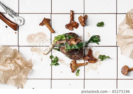 Grilled beef steak with chanterelles on white tiles background Grilled beef steak with chanterelles on white tiles background 85273196