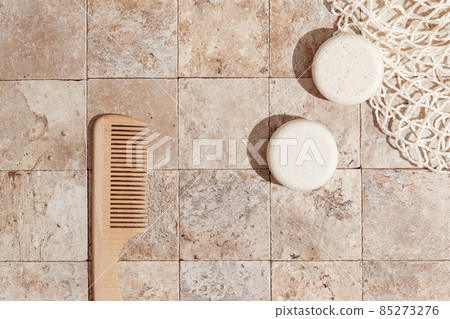 Zero waste care for skin - dry shampoo, wood brush on earth toned stone tales top view direct sunlight Zero waste care for skin - dry shampoo, wood brush on earth toned stone tales top view direct sunlight 85273276