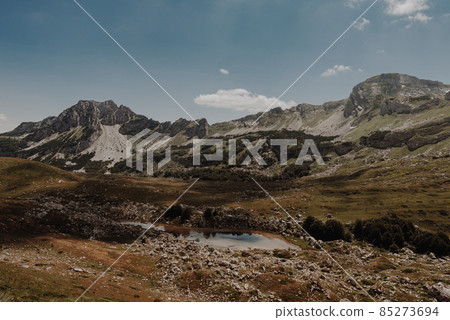 Mountain landscape. Mountains with green grass and bright blue sky. Idyllic panorama. Tourism concept. Hiking. Vacation in Europe. Relax in the open air and the spirit of adventure. Ecology of nature 85273694