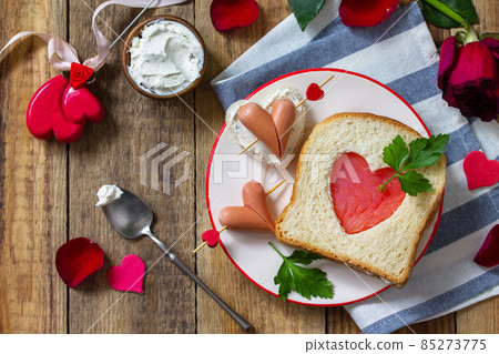 Breakfast for valentine's day or mother's day. Toast with salmon and cheese with the inscription that I love you, on a rustic table. 85273775