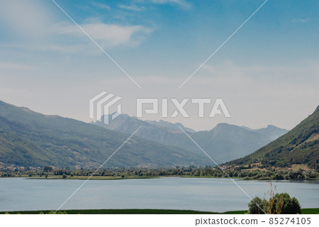 Montenegro. Kotor Bay. A picturesque view from the water to the coastal town of Dobrota. Kotor bay in a beautiful summer day, Montenegro Montenegro. Kotor Bay. A picturesque view from the water to the coastal town of Dobrota. Kotor bay in a beautiful summer day, Montenegro 85274105