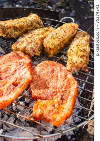 Home barbecue in the garden of the house Pork saute with sauce and pork ribs Home barbecue in the garden of the house Pork saute with sauce and pork ribs 85274241