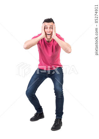 Excited man touching face in studio. White background 85274911