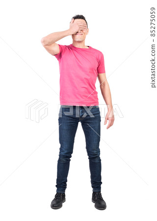 Man covering eyes with hand in studio 85275059