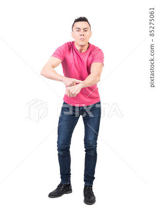 Unsatisfied man pointing on wrist due to late Unsatisfied man pointing on wrist due to late 85275061