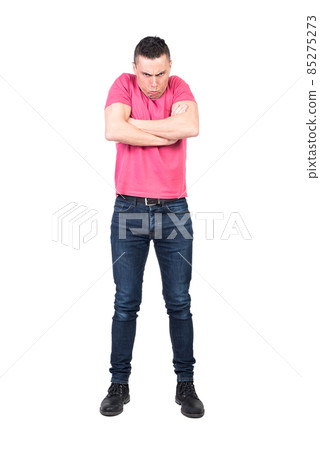 Annoyed man with folded hands pouting lips and looking at camera Annoyed man with folded hands pouting lips and looking at camera 85275273