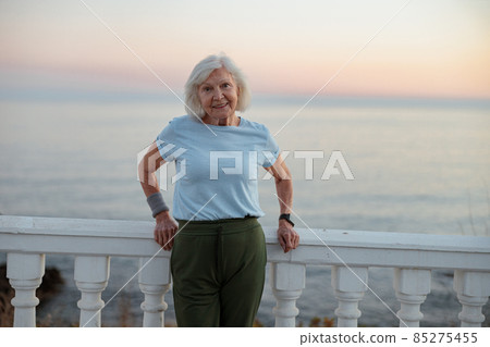 Good looking senior lady posing at beautiful park Good looking senior lady posing at beautiful park 85275455