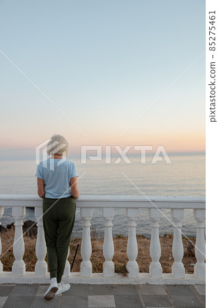 Caucasian senior sportswoman relaxing at sea coast Caucasian senior sportswoman relaxing at sea coast 85275461