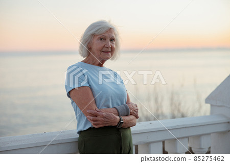 Attractive female pensioner breathing fresh air outdoors Attractive female pensioner breathing fresh air outdoors 85275462