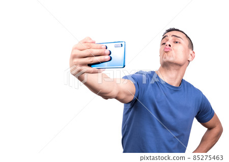 Man taking a selfie while blowing a kiss with mobile 85275463
