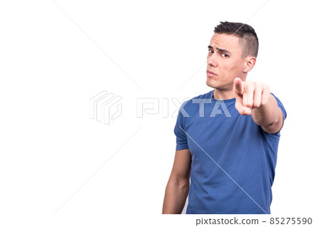 Serious man pointing forward while standing Serious man pointing forward while standing 85275590