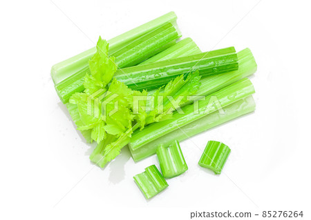 Fresh Chopped Celery Sticks and Slices with Leaves and Water Drops Isolated on White Background Fresh Chopped Celery Sticks and Slices with Leaves and Water Drops Isolated on White Background 85276264