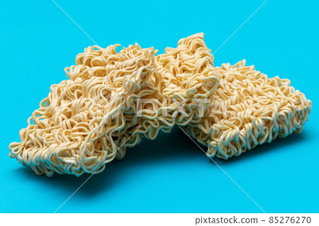 Uncooked Instant Noodles on Blue Background Uncooked Instant Noodles on Blue Background 85276270