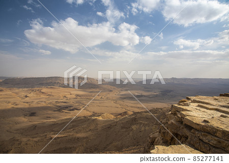 Ramon Crater Makhtesh Ramon, the largest in the world, as seen from the high rocky cliff edge surrounding it from the north, Ramon Nature reserve, Mitzpe Ramon, Negev desert, Israel Ramon Crater Makhtesh Ramon, the largest in the world, as seen from the high rocky cliff edge surrounding it from the north, Ramon Nature reserve, Mitzpe Ramon, Negev desert, Israel 85277141