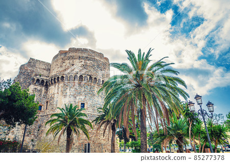 Aragonese Castle Castello Aragonese stone medieval buildings and palm trees in Piazza castello square in Reggio Calabria Aragonese Castle Castello Aragonese stone medieval buildings and palm trees in Piazza castello square in Reggio Calabria 85277378
