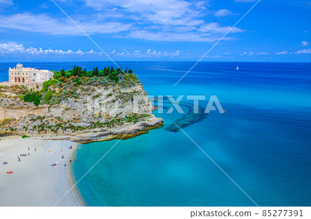 Monastery Sanctuary church Santa Maria dell Isola on top of rock of Tyrrhenian Sea and green trees Monastery Sanctuary church Santa Maria dell Isola on top of rock of Tyrrhenian Sea and green trees 85277391