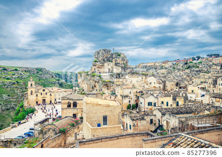 Rock church Santa Maria De Idris with big cross and Chiesa San Pietro Caveoso in Sassi di Matera town historical centre Rock church Santa Maria De Idris with big cross and Chiesa San Pietro Caveoso in Sassi di Matera town historical centre 85277396