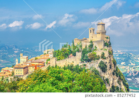 Republic San Marino Prima Torre Guaita first fortress tower with brick walls on Mount Titano stone rock with green trees 85277452