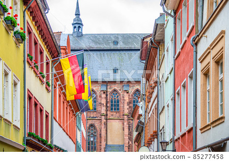 Street with typical german houses with colorful walls and german flags and Church of Holy Spirit Heiliggeistkirche Street with typical german houses with colorful walls and german flags and Church of Holy Spirit Heiliggeistkirche 85277458