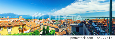 Panorama of Desenzano del Garda town with red tiled roof buildings, Garda Lake water 85277517