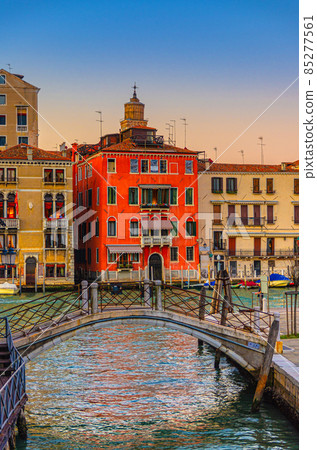 Bridge across narrow water canal and baroque style buildings palaces on Grand Canal waterway in Venice Bridge across narrow water canal and baroque style buildings palaces on Grand Canal waterway in Venice 85277561
