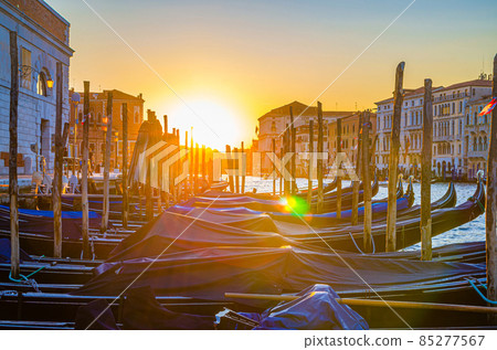 Gondolas moored docked on pier of Grand Canal waterway in Venice 85277567