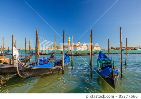 Gondolas moored docked on water in Venice 85277666