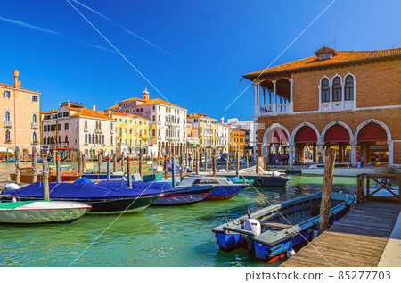 Boats moored in wooden pier dock of Grand Canal waterway in Venice 85277703